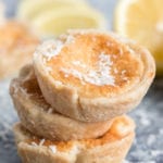 Stack of lemon tarts with lemons in the background