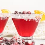 Cranberry martini with sugared rim and a dish of sugared cranberries.