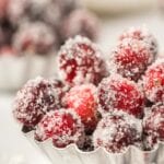 Close up of sugared cranberries in a small metal tart tin.