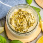 Mayonnaise mixed with pesto in a small glass jar.