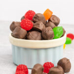 A bowl of chocolate covered jujubes.