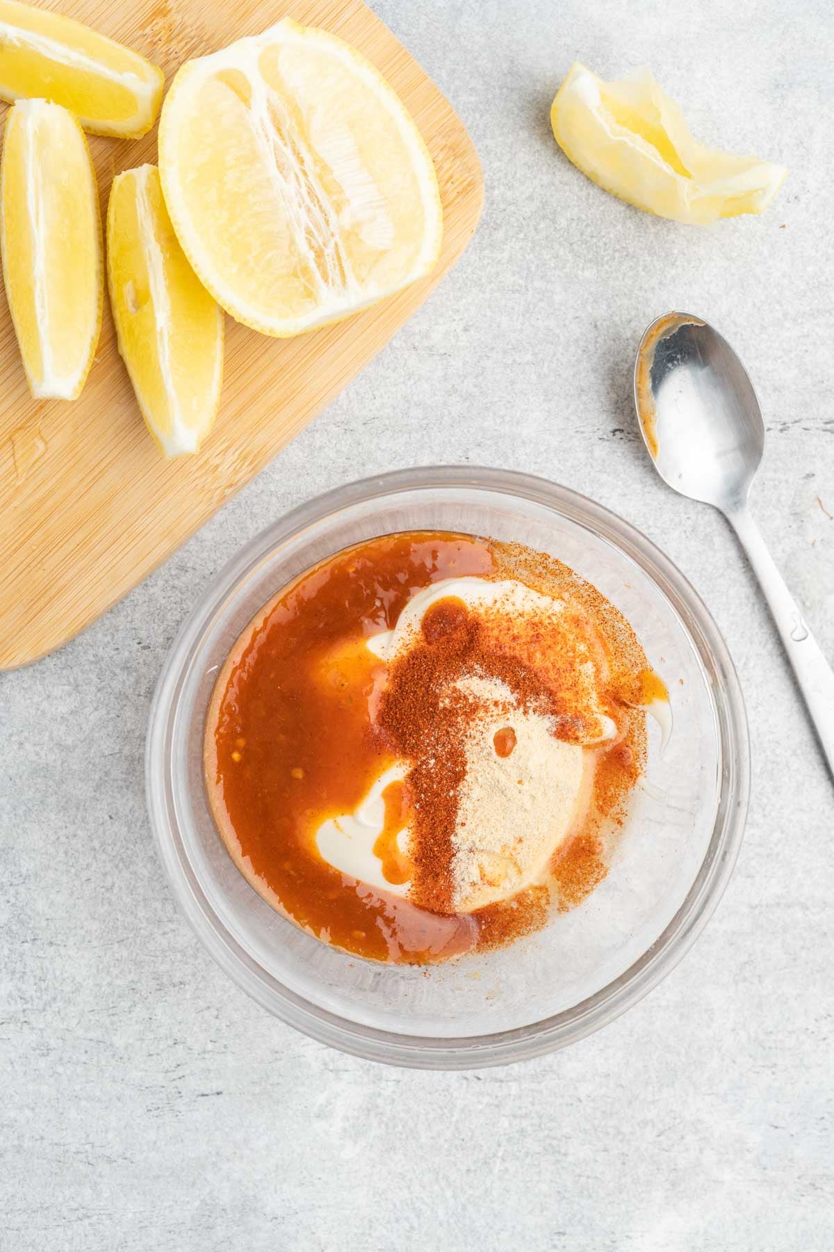 Ingredients to make peri-peri mayo in a small glass bow. 