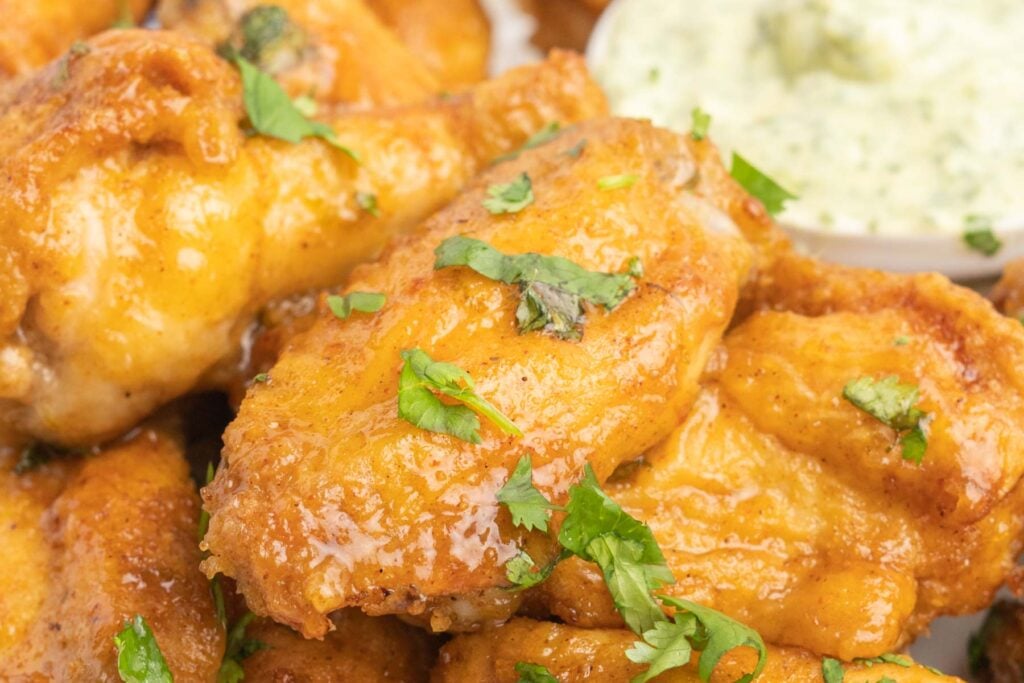 Tequila lime chicken wings with chopped cilantro on a plate.