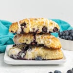 A stack of blueberry scones with icing drizzle.