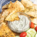 Herb pita chips with dip and veggies.