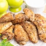 A plate of salt and pepper chicken wings with ranch dip.