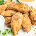Breaded chicken wings on a plate.