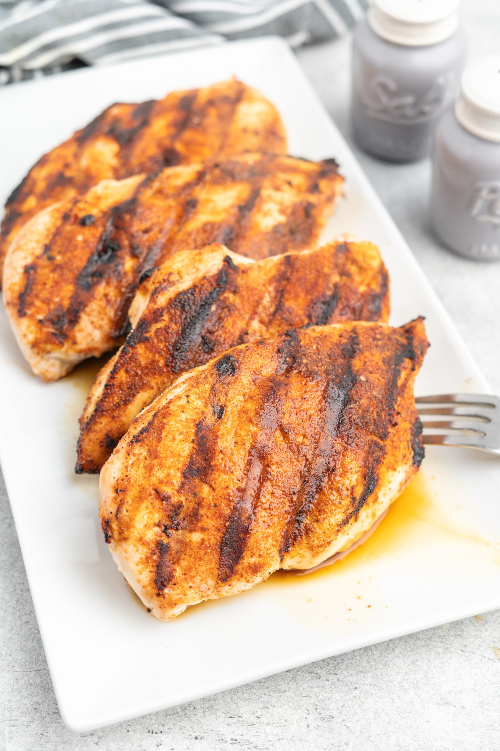 Grilled chicken breasts on a platter.