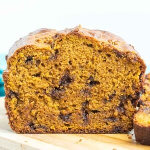 Chocolate chip pumpkin loaf on a cutting board.