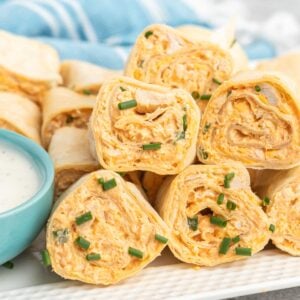 Buffalo chicken rollups in tortillas on a plate.