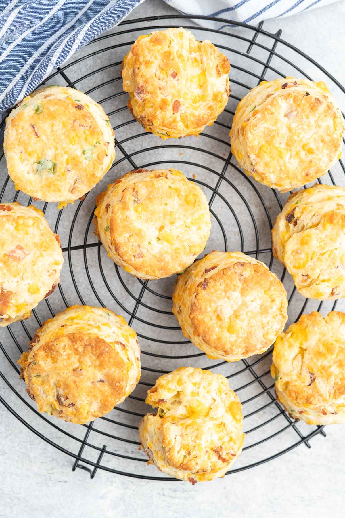 Cheddar bacon onion biscuits on a cooling rack.