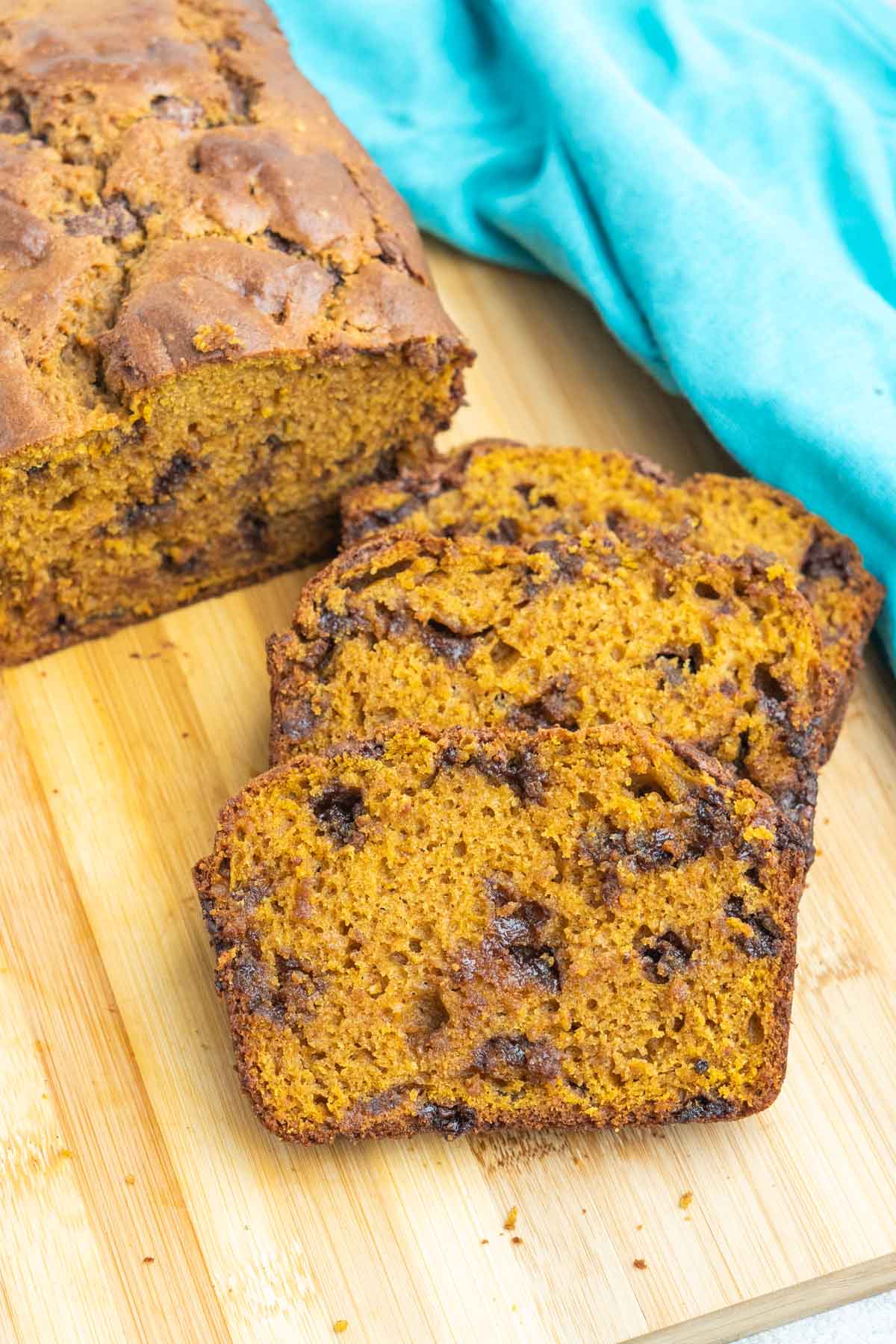 Chocolate chip pumpkin bread slices on a cutting board.