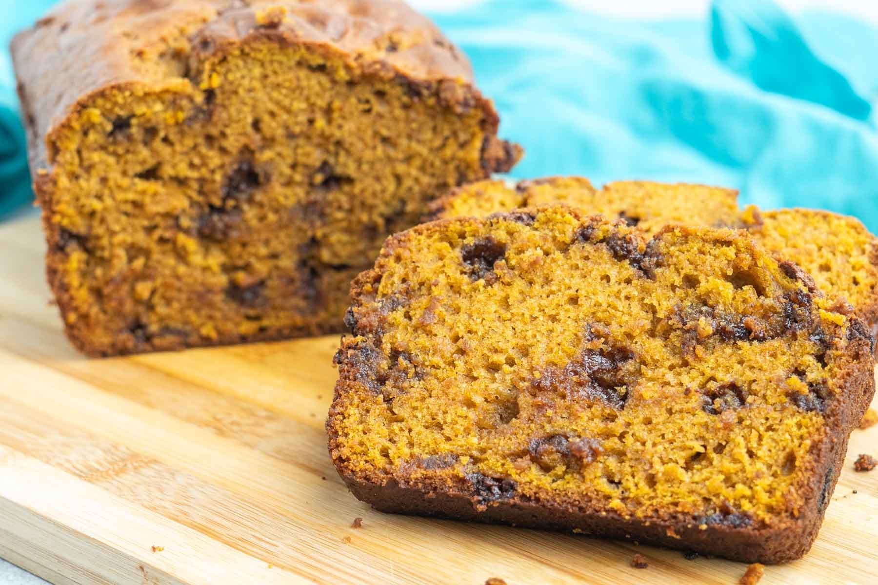 Sliced chocolate chip pumpkin bread on a cutting board.